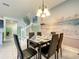 Dining room with a table, seating for six, beach mural, and view of stairs at 826 Paradise Dr, Davenport, FL 33897