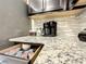 Open kitchen drawer stocked with single-serve coffee pods, showcasing the granite countertops at 826 Paradise Dr, Davenport, FL 33897