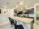 Modern kitchen with island seating, dark cabinets, and stainless steel appliances at 826 Paradise Dr, Davenport, FL 33897