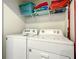 Laundry room with washer, dryer, and shelving for storage at 826 Paradise Dr, Davenport, FL 33897