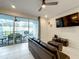 Living room with patio access, flat-screen TV and comfy seating at 826 Paradise Dr, Davenport, FL 33897