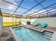 Private screened-in pool area with lounge chairs, grill, and spa at 826 Paradise Dr, Davenport, FL 33897