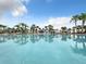 Relaxing resort-style pool with palm trees and lounge chairs at 826 Paradise Dr, Davenport, FL 33897