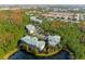 Community buildings nestled amongst trees at 9051 Treasure Trove Ln # 102, Kissimmee, FL 34747