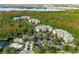 Aerial view of the community surrounded by lush greenery at 9051 Treasure Trove Ln # 102, Kissimmee, FL 34747