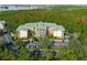 Aerial view of the condo building surrounded by trees and parking at 9051 Treasure Trove Ln # 102, Kissimmee, FL 34747