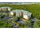 An aerial perspective of the condo complex nestled in a wooded area at 9051 Treasure Trove Ln # 102, Kissimmee, FL 34747