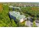 Aerial perspective of the condo building amidst lush greenery at 9051 Treasure Trove Ln # 102, Kissimmee, FL 34747