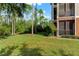 Lush backyard with trees and well-maintained lawn at 9051 Treasure Trove Ln # 102, Kissimmee, FL 34747