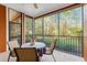 Screened balcony with outdoor table and chairs, overlooking peaceful green space at 9051 Treasure Trove Ln # 102, Kissimmee, FL 34747