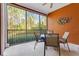 Spacious screened balcony with ceiling fan, outdoor dining area, and tranquil views at 9051 Treasure Trove Ln # 102, Kissimmee, FL 34747