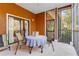 Screened balcony with table and chairs, overlooking the surrounding trees at 9051 Treasure Trove Ln # 102, Kissimmee, FL 34747