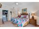 Bedroom features a king-size bed, matching nightstands, and decorative wall art at 9051 Treasure Trove Ln # 102, Kissimmee, FL 34747