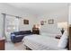 A bedroom with twin beds, a small seating area, and a window with blinds at 9051 Treasure Trove Ln # 102, Kissimmee, FL 34747