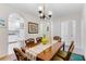 Dining room with wicker table and chairs, view of the kitchen, and decorative art at 9051 Treasure Trove Ln # 102, Kissimmee, FL 34747