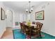 Dining area with wicker chairs, a dining table, and a tiger-themed rug at 9051 Treasure Trove Ln # 102, Kissimmee, FL 34747