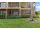 Close-up view of the condo's screened balconies and landscaped grounds at 9051 Treasure Trove Ln # 102, Kissimmee, FL 34747