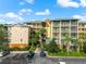 Aerial perspective of the condo building, highlighting its architecture, balconies, and surrounding greenery at 9051 Treasure Trove Ln # 102, Kissimmee, FL 34747