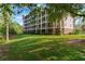 View of the condo building's exterior from the green lawn at 9051 Treasure Trove Ln # 102, Kissimmee, FL 34747