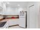 White kitchen featuring white appliances, and granite countertops at 9051 Treasure Trove Ln # 102, Kissimmee, FL 34747