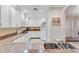 Bright kitchen with white cabinets, granite counters, white appliances at 9051 Treasure Trove Ln # 102, Kissimmee, FL 34747
