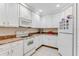 Kitchen with white appliances and cabinets, granite counters at 9051 Treasure Trove Ln # 102, Kissimmee, FL 34747