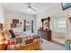 Main bedroom with ceiling fan, ensuite bathroom, and carpeted floors at 9051 Treasure Trove Ln # 102, Kissimmee, FL 34747