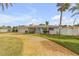 Inviting front yard with a circular driveway and tropical palm trees at 1130 Jacaranda Ave, Daytona Beach, FL 32118