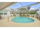 Screened-in pool area with ample seating and lush greenery at 1130 Jacaranda Ave, Daytona Beach, FL 32118