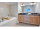 Elegant bathroom with a soaking tub, dual vanities, and modern fixtures at 150 E Robinson St # 2801, Orlando, FL 32801