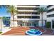 Modern building exterior with a water feature and palm trees at 150 E Robinson St # 2801, Orlando, FL 32801