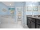 Ensuite bathroom featuring a jetted tub, walk-in shower, dual vanity, and patio access at 1528 Mulligan Blvd, Davenport, FL 33896