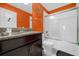 Modern bathroom with granite countertops, dark wood cabinets, and a shower/tub combo at 1528 Mulligan Blvd, Davenport, FL 33896