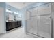 Modern ensuite bathroom with walk-in shower, dual vanity, and light blue walls at 1528 Mulligan Blvd, Davenport, FL 33896