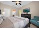 Comfortable bedroom featuring a king-size bed, a teal accent chair, and a dresser at 1528 Mulligan Blvd, Davenport, FL 33896