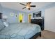 Bedroom with king-size bed, ceiling fan, dresser, TV, and ensuite bathroom access at 1528 Mulligan Blvd, Davenport, FL 33896