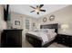 Relaxing bedroom with king-size bed, ceiling fan, and dark wood furniture at 1528 Mulligan Blvd, Davenport, FL 33896