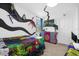 Whimsical Alice in Wonderland bedroom with a unique bed, wall art, and TV at 1528 Mulligan Blvd, Davenport, FL 33896