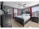Hollywood-themed main bedroom with king-size bed, black furniture, and red accents at 1528 Mulligan Blvd, Davenport, FL 33896