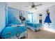 Frozen-themed bedroom with two twin beds, ceiling fan, and whimsical decor at 1528 Mulligan Blvd, Davenport, FL 33896