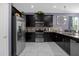 Modern kitchen with stainless steel appliances and dark cabinets at 1528 Mulligan Blvd, Davenport, FL 33896