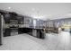 Open-concept kitchen and living room with stainless steel appliances at 1528 Mulligan Blvd, Davenport, FL 33896