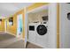 Convenient laundry room with modern washer and dryer units and extra storage space at 1528 Mulligan Blvd, Davenport, FL 33896