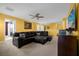 Open living room with leather sectional, entertainment center, and versatile layout at 1528 Mulligan Blvd, Davenport, FL 33896