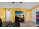 Inviting living area with leather sectional sofa, media console, and yellow walls at 1528 Mulligan Blvd, Davenport, FL 33896