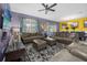 Open-concept living area with multiple seating arrangements and views of the dining area and pool at 1528 Mulligan Blvd, Davenport, FL 33896