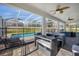 Screened-in patio with seating and a pool protected by a safety fence at 1528 Mulligan Blvd, Davenport, FL 33896