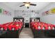 ' bedroom with Mickey Mouse theme featuring two twin beds and a Disney comic mural at 1530 Moon Valley Dr, Davenport, FL 33896