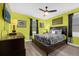 Lime green bedroom with dark wood furniture and ceiling fan at 1530 Moon Valley Dr, Davenport, FL 33896