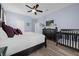 Spacious main bedroom with crib, TV, and ceiling fan at 1530 Moon Valley Dr, Davenport, FL 33896